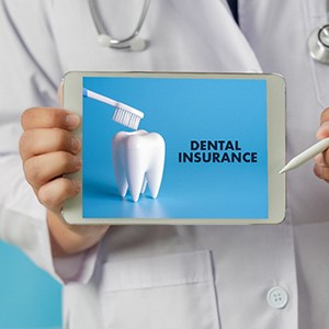 Dentist holding a tablet with Dental Insurance on it
