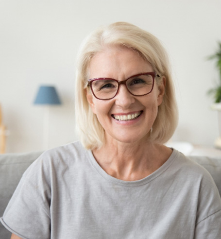 Woman with glasses sitting on couch
